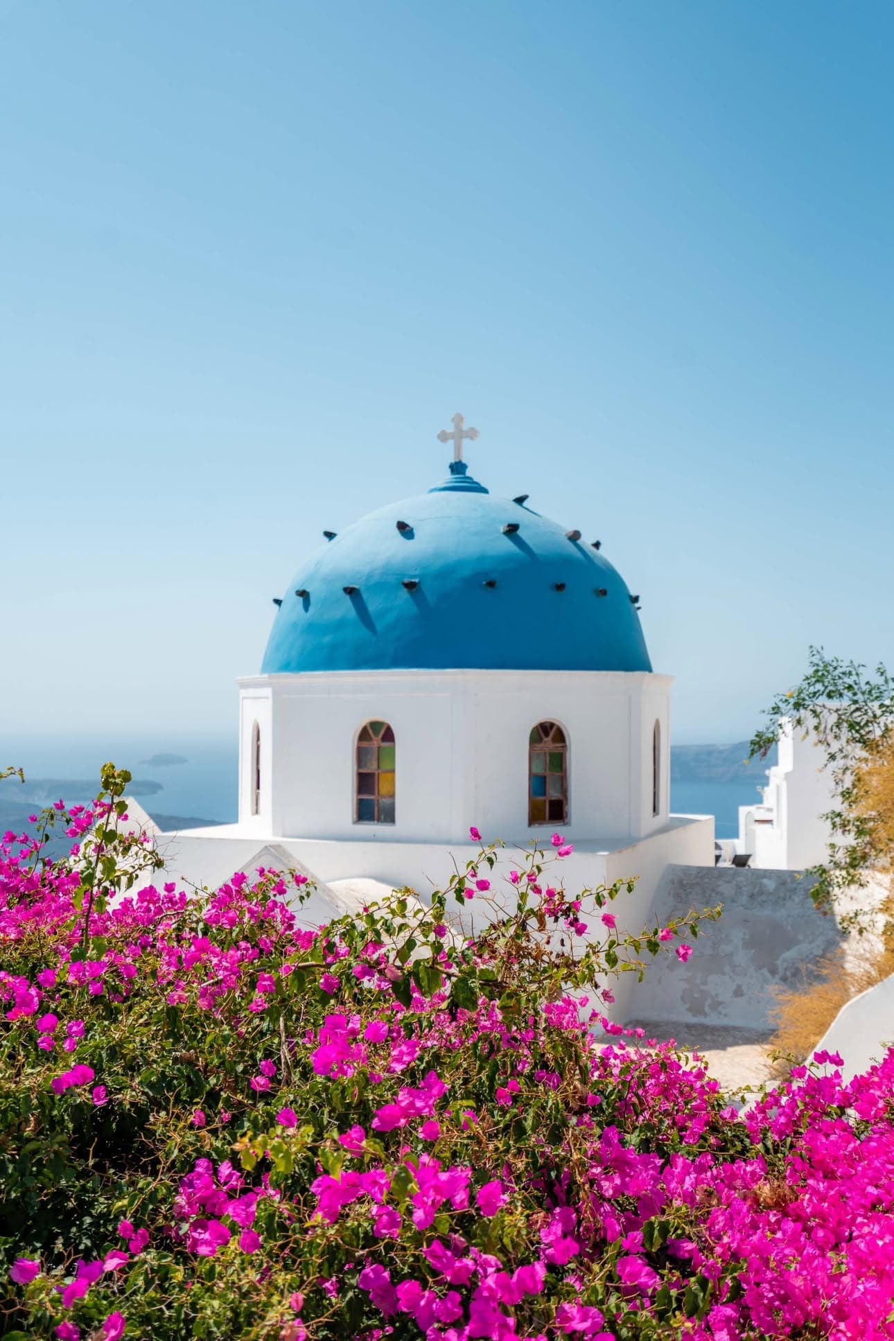 Santorini blue domes and white churches overlooking the caldera